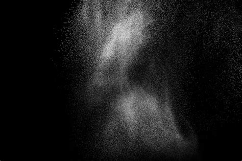 Premium Photo | White powder explosion isolated on black background.white dust particles splash.