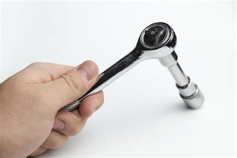 Hand holds a ratchet. 4968135 Stock Photo at Vecteezy