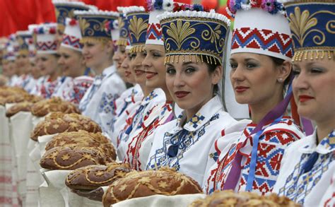 People wearing the Belarusian national dress and...