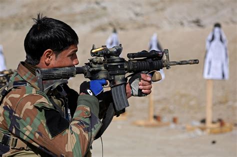 An Afghan army special forces soldier fires his weapon at a target during weapons zeroing on a ...