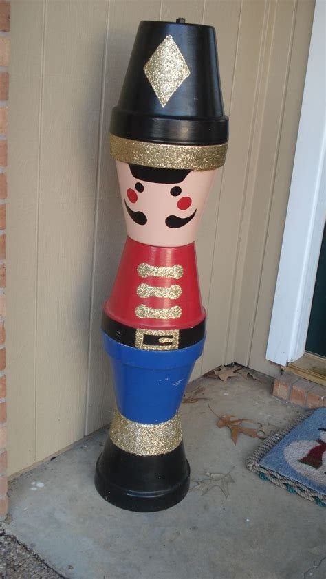 Create your own clay pot Christmas soldier by stacking clay pots on top of each other ...