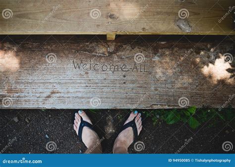 Feet with Welcome All sign stock image. Image of natural - 94950085