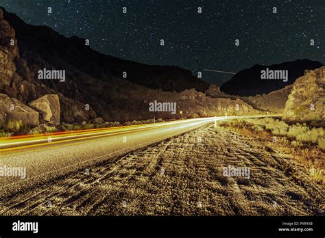 Starry night on a deserted desert road Stock Photo - Alamy