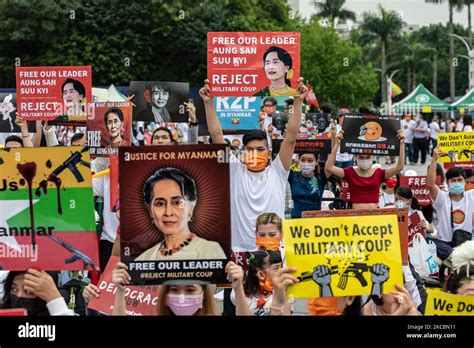 Group of people holding signs with Myanmar official Leader Aung San Suu ...