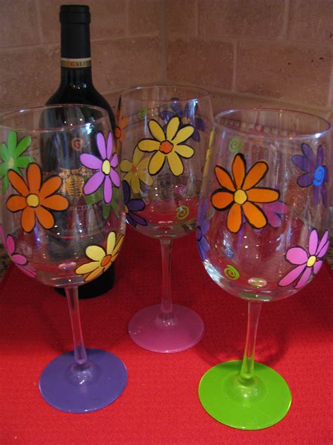 Simple flower design on wine glasses. Each base a different color so u know which glass is yours ...