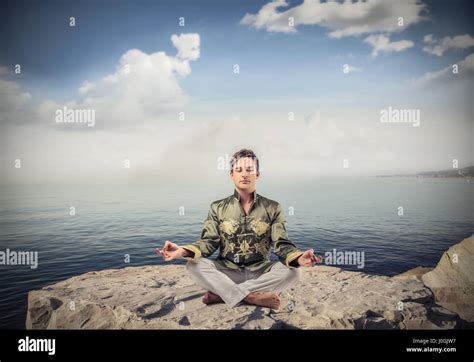 Man meditating on the beach Stock Photo - Alamy