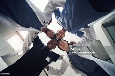 Shot Of A Group Of Medical Staff Huddled Together Stock Photo - Download Image Now - Doctor ...