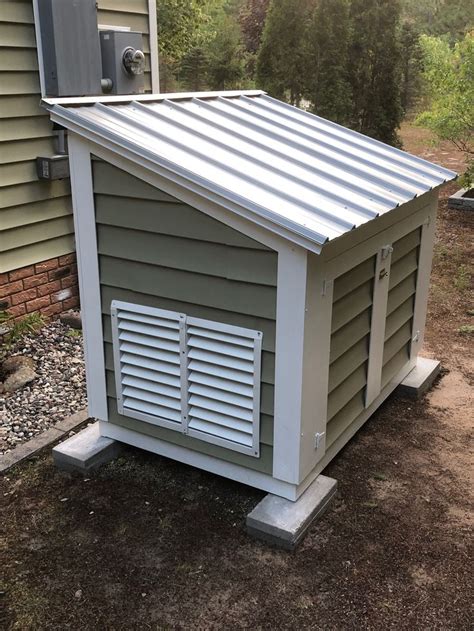 a dog house with a metal roof and shutters