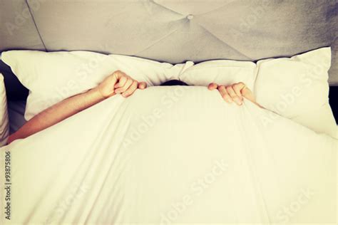 Man hiding in bed under sheets. Stock Photo | Adobe Stock