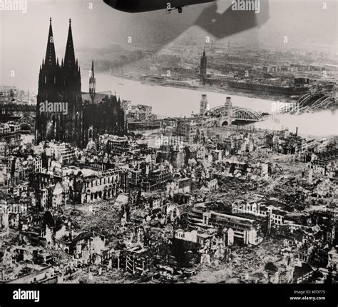 The Cologne cathedral stands tall amidst the ruins of the city after ...