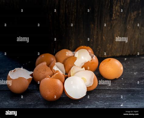 Egg shells on dark wooden plank and log with empty space Stock Photo ...