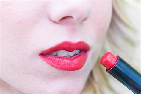 Premium Photo | Cropped image of woman applying lipstick