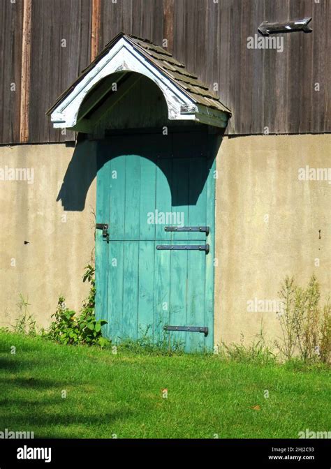 Barn door, old blue and green,with lock, hinges and small roof cover ...