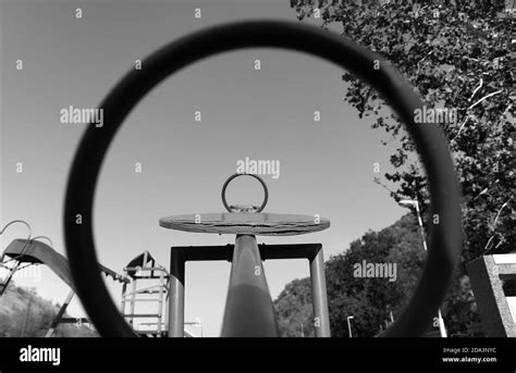 Abstract black and white photo of an empty kids playground. Two circles of teeter totter Stock ...