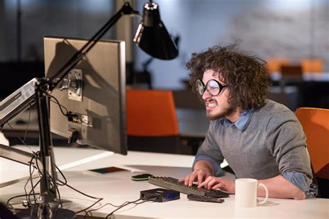 man working on computer in dark startup office 12134426 Stock Photo at Vecteezy