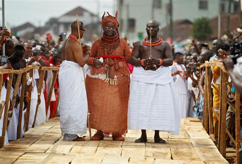 Newly crowned Oba of Benin Kingdom Eheneden Erediauwa is guided through a symbolic bridge by the ...