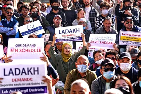 People from Ladakh, hold placards stage a protest