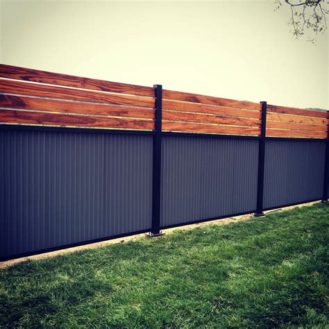 Custom privacy fence. Built out of metal post, tiger wood, and corrugated metal. | Privacy fence ...