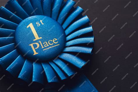 Premium Photo | Champion 1st place blue rosette with gold text on black background