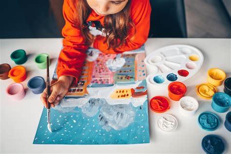 Premium Photo | A child paints a winter New Year's landscape