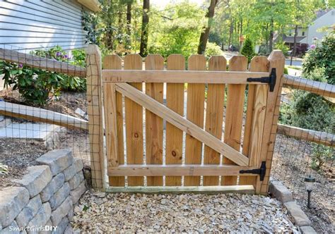 a wooden gate is open on the side of a house in front of a stone wall