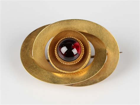 A Victorian gold and carbuncle garnet brooch, circa 1870, the circular ...