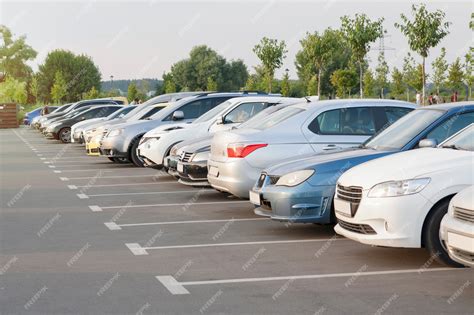 Premium Photo | Cars in a parking lot in the evening light of the sun