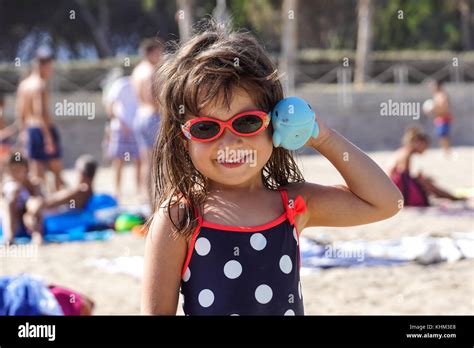 NICE, FRANCE - August 2017 : her little girl smiles and plays at the ...