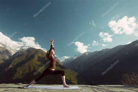 Woman in mountains doing yoga exercises — Stock Photo © AnnaTamila ...