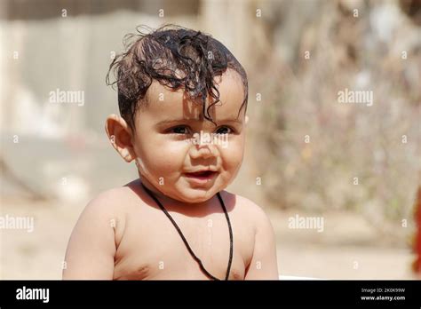 Close-up photo of smiling face Adorable baby boy with funny expression and without clothes ...