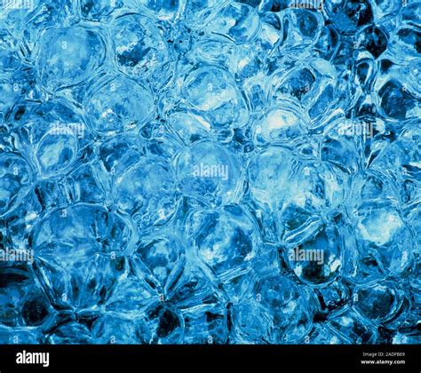 Ice formed from a waterfall splashing onto a boulder Stock Photo - Alamy