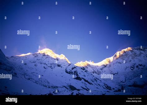 Nepal, Himalayas, sunrise touching the tips of the Annapurna mountains ...