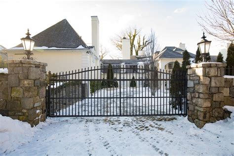 Simple metal sliding automated driveway gate. Rustic stone pillars. https://www.tristategate.com ...