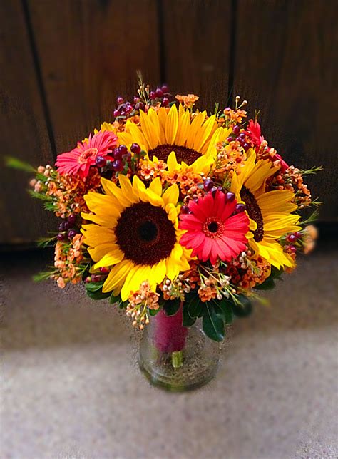 Fall bridal bouquet with sunflowers, gerber daisies, wax flower and hypericum berries ...