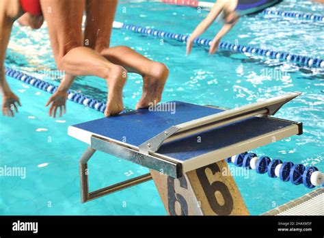 Close-up shot of human legs on the starting block of the swimming pool ready to jump Stock Photo ...