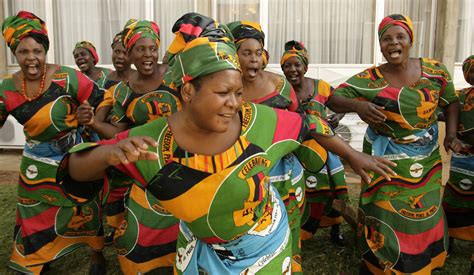 Zambian women sing at Lusaka's international airport in 2008. | Woman singing, How to make ...