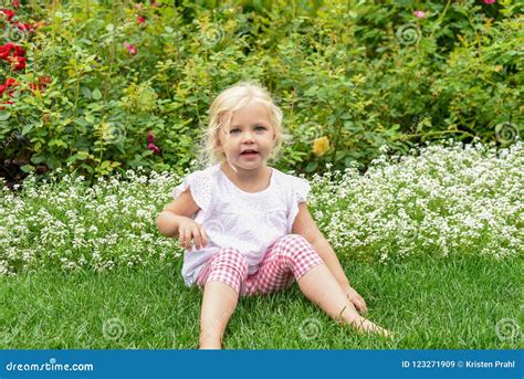 Cute Little Girl Sitting in the Grass in the Garden Stock Image - Image of childhood, outside ...