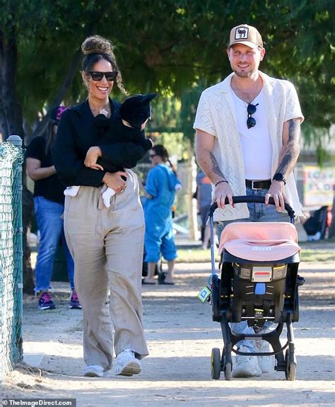 Leona Lewis holds her baby girl while attending a Halloween festival ...