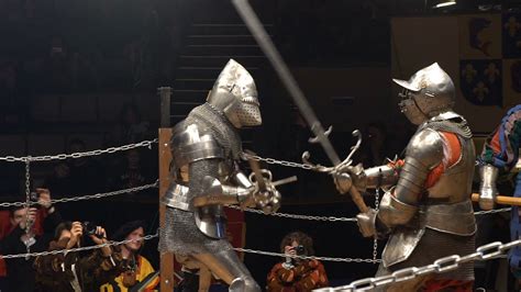 Two medieval knight fighting in the arena with two-handed swords. Slow ...