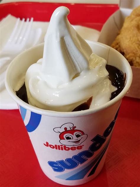 an ice cream sundae with chocolate sauce and whipped cream in a plastic ...