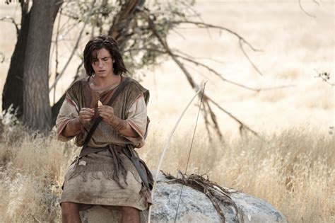 Nephi making a bow and arrow in the wilderness