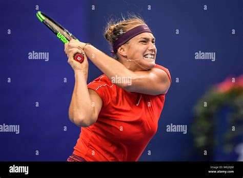 Aryna Sabalenka of Belarus returns a shot to Ashleigh Barty of ...