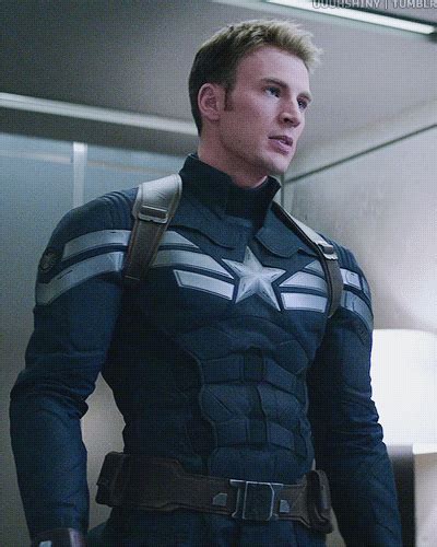 a man dressed as captain america standing in an elevator with his hands on his hips