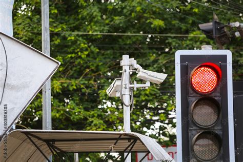 Traffic light with CCTV monitoring, security cameras at a intersection. Stock Photo | Adobe Stock