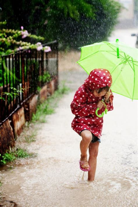 Little Girl Walking In The Rain Stock Photo - Image: 15108386