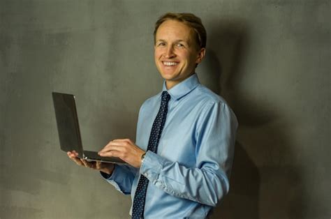 Premium Photo | Man with laptop smiling and confident