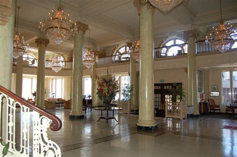 an elegant lobby with chandeliers and marble floors