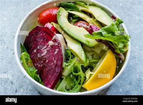 Healthy Fast Food Take Away Salad with Avocado, Beet Slice, Lettuce, Cherry Tomatoes and Sauce ...