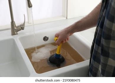 Man Using Plunger Unclog Sink Drain Stock Photo 2193080475 | Shutterstock