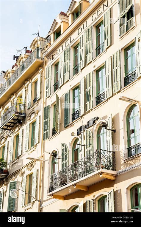 The facade of the Hotel du Centre Nice Provence South of France. French architecture, shutters ...